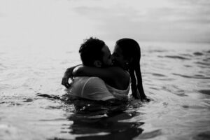 couple kissing in ocean