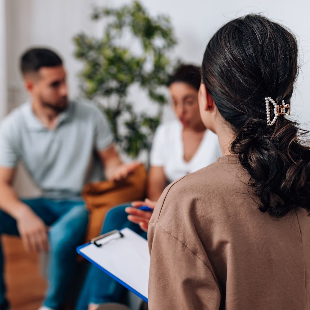 Therapist listens as couple explains relationship challenges