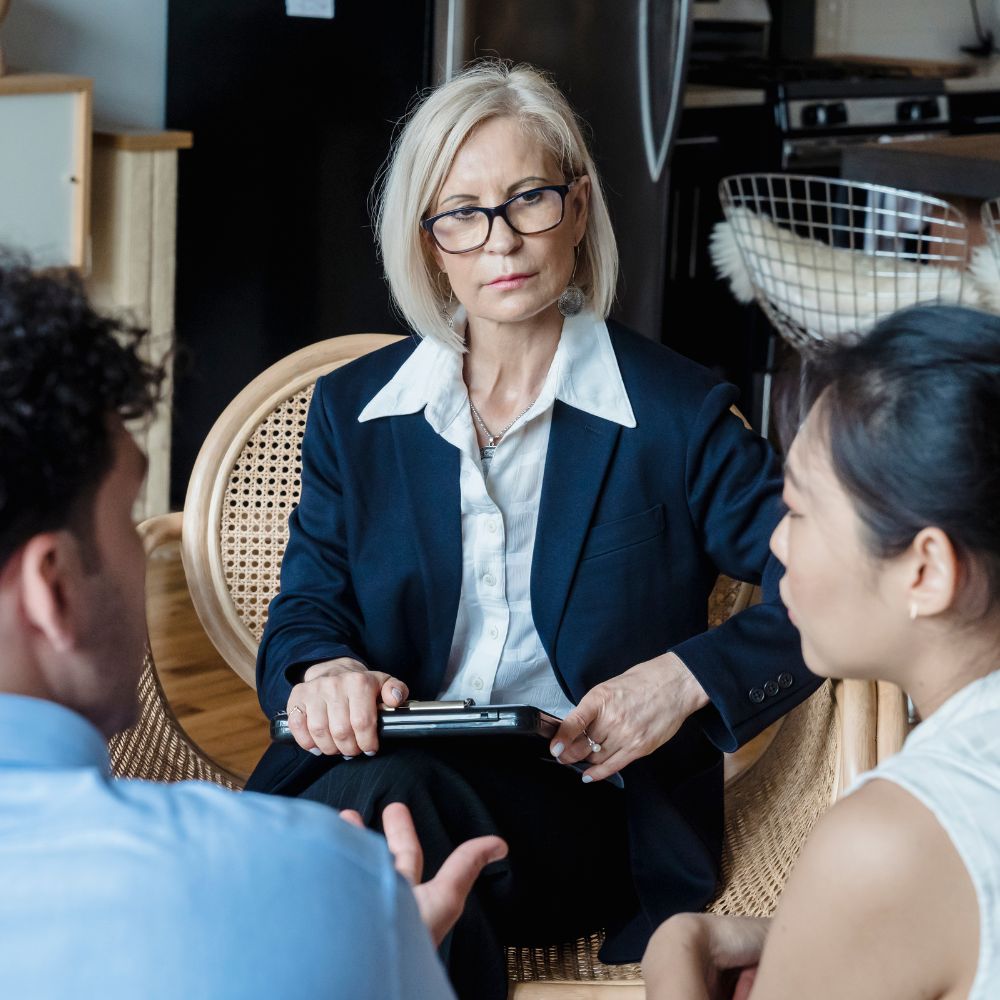 Therapist attentively listening to couple’s emotional conversation