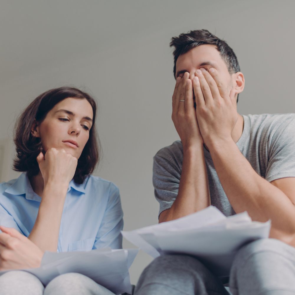 Couple thinking and overwhelmed during financial stress