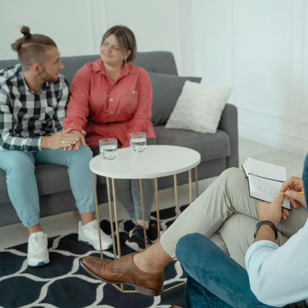 Couple holding hands during supportive therapy meeting