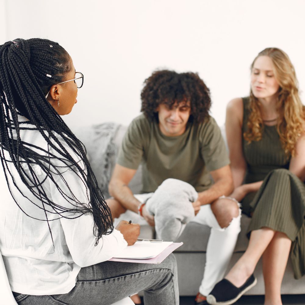 Couple talking to therapist during counseling session