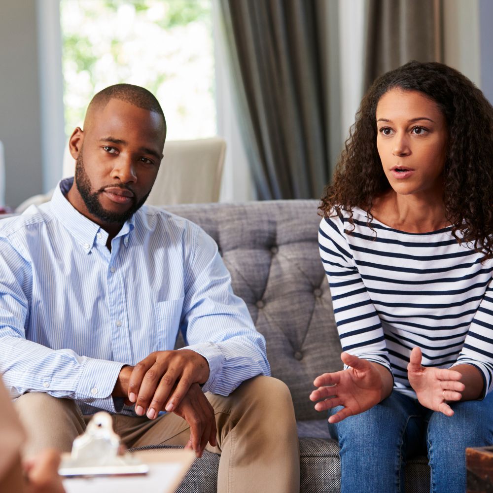 Woman speaking in a serious couple counseling