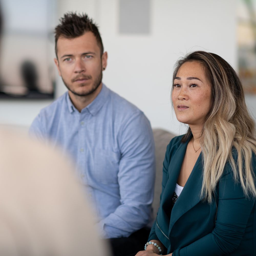 Attentive couple listening to therapist in session