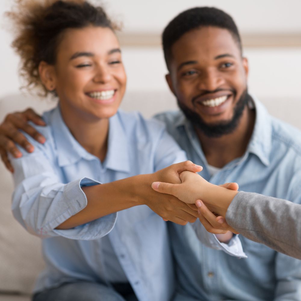 Couple holding hands during therapy appointment