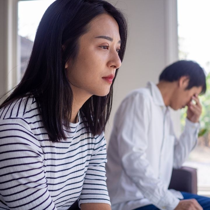 Female counselor with a couple during a discussion, with a coffee cup on the table in front of her
